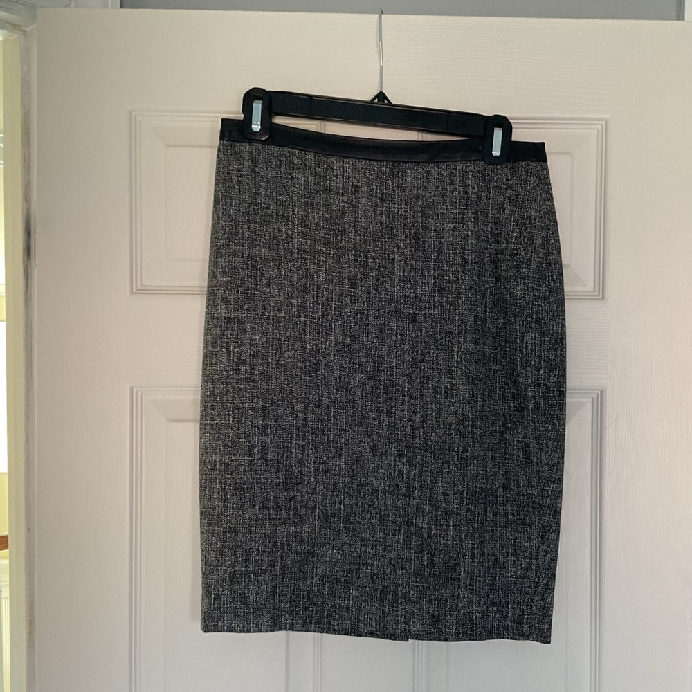 Black/white skirt; black leather waist border; zip back; straight to knee
